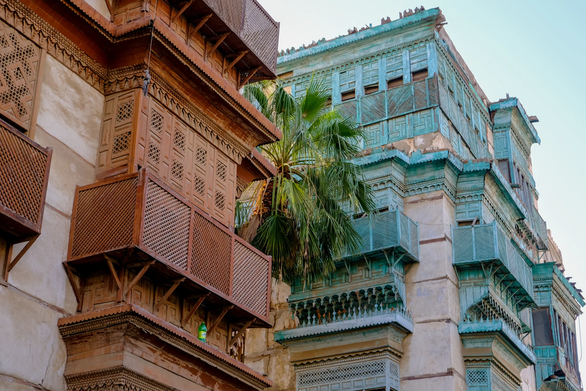 Traditional carved wooden balconies and turquoise rawasheen in Al Balad, historic Jeddah